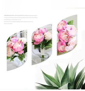 Detailed views of pink silk peonies bridal bouquet and greenery on a white background