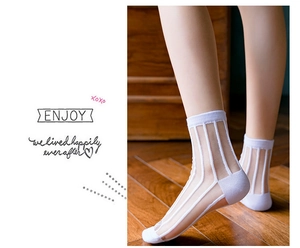 Detail of white semi-transparent crew socks featuring a vertical stripe texture for women