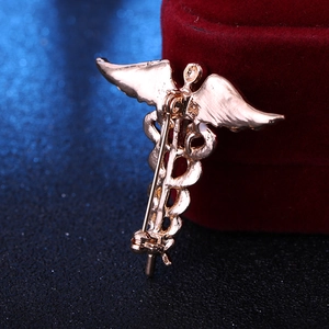Rose gold medical Caduceus brooch with serpent wings and secure rotating pin back clasp