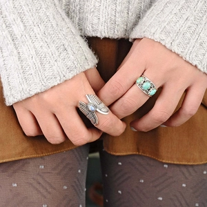 Vintage silver angel wing ring with moonstone and boho turquoise jewelry on fingers