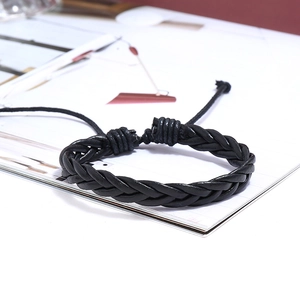 Close-up of black braided leather bracelet with adjustable knot and woven craftsmanship