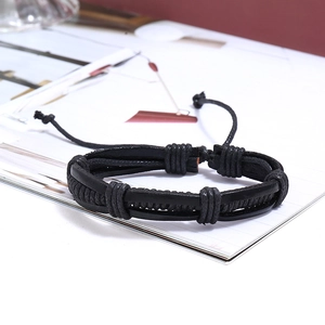Close-up of black braided leather bracelets with multi-strand cord details