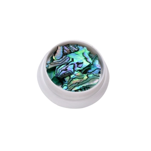 Irregular green abalone shell fragments in a white jar for ultra-thin Japanese nail art decor