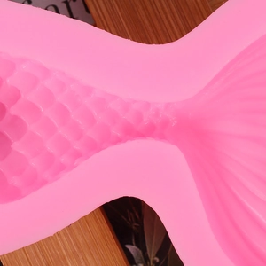 Close-up of pink silicone mermaid tail mold showing intricate fish scale and fin texture