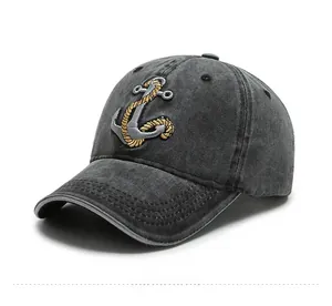 Detail of nautical anchor embroidery with gold and silver threads on vintage denim cap