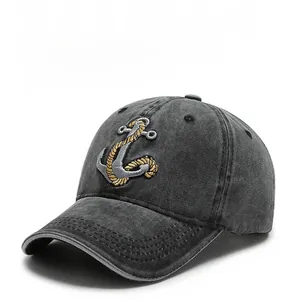Detail of nautical anchor embroidery and washed vintage texture on a cotton baseball cap