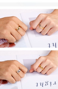 Polished titanium steel couple rings with small diamonds shown on hand model