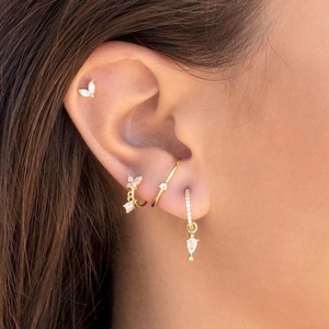 Detailed view of s925 silver gold butterfly earrings set with sparkling cubic zirconia stones