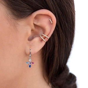 Gold s925 silver earrings set with colorful zircon cross charms on a female model
