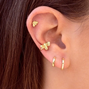 Vintage 18k gold bee ear cuff and hoop earrings set on female model in warm lighting
