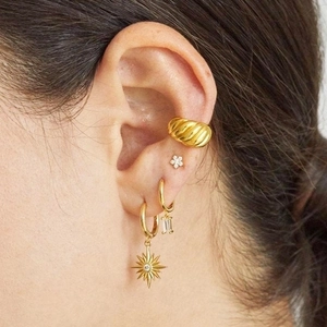 Minimalist gold starburst and zircon drop earrings set for women on ear model