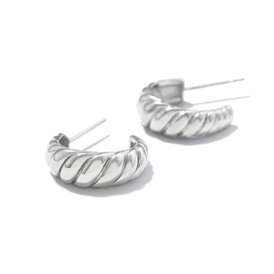 Polished silver croissant hoop earrings with French twisted texture on white background