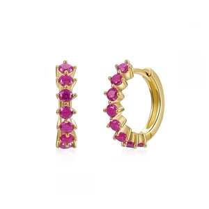 Close-up of gold hoop earrings with round pink zircons and polished finish details
