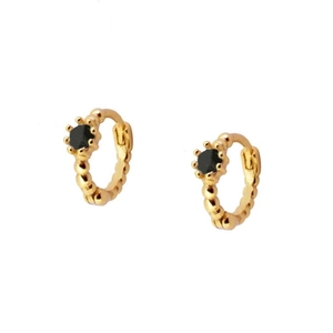 Detailed shot of gold hoop earrings with black gemstone and beaded edge textures
