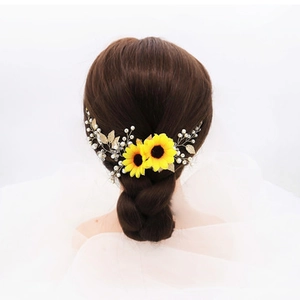 Detail of bridal hairband with yellow sunflowers, golden leaves and white pearls
