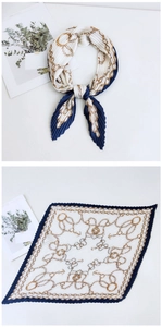 Detail of pleated square scarf featuring vintage gold chain print and navy blue borders