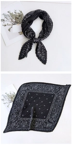 Detail of pleated black neck scarf with white celestial sun and moon astrological patterns