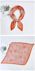 Detailed pleated orange silk scarf featuring pink paisley pattern and textured fold finish