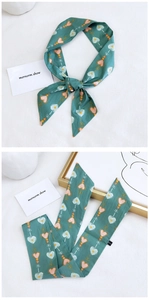 Detail of dark green cotton linen neck scarf featuring vintage heart and arrow patterns
