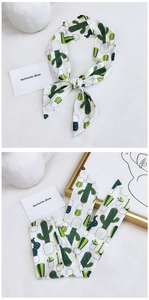 Detail of white cotton linen scarf with green cactus print and soft chiffon texture