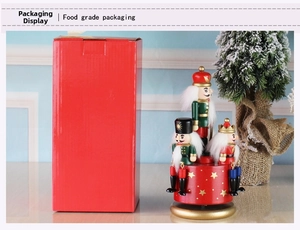 Detail view of Nutcracker music box with hand-painted soldiers and red gift box