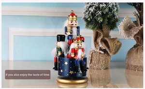 Close-up of hand-painted Nutcracker music box with gold stars on a blue wooden base