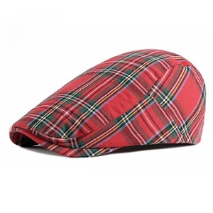 Detailed close-up of red and green plaid pattern on this classic British newsboy cap