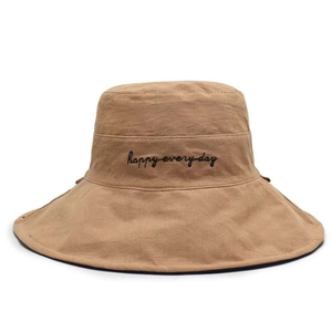 Detail of khaki sun hat featuring embroidered happy everyday text and wide brim