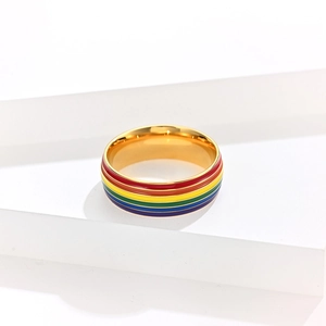 Macro detail of rainbow enamel stripes on a polished gold-plated stainless steel ring