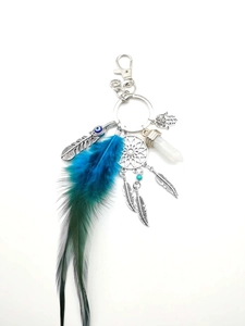 Detail of dreamcatcher keychain with blue feathers, Hamsa hand, and evil eye charm