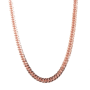 Macro shot of 8mm rose gold Cuban link necklace showing the textured metal links