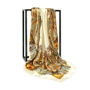 Classic paisley print satin silk scarf draped elegantly on a display stand