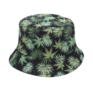 Reversible outdoor bucket hat featuring green leaf print on black cotton fabric