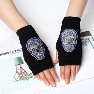 Black fingerless knit gloves with colorful skull embroidery for a trendy gothic look