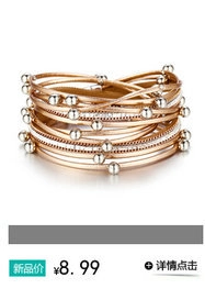 Close-up of multilayer leather wrap bracelet with turquoise beads and metallic details
