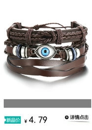 Detail of vintage multilayer leather bracelet featuring a turquoise evil eye charm