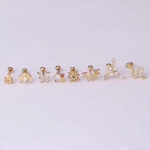 Set of 8 gold stainless steel stud earrings with colorful cubic zirconia on purple base