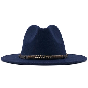 Detail of dark blue wool fedora hat with brown leather belt and bronze metal studs