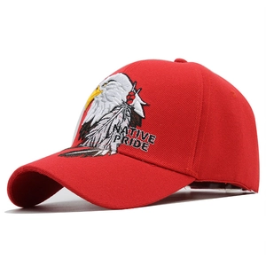 Close-up of red baseball cap featuring detailed eagle embroidery and Native Pride text