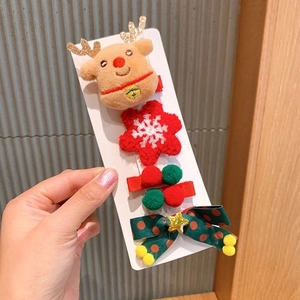 Detail of Christmas hair clip set with plush reindeer and festive crochet bow patterns