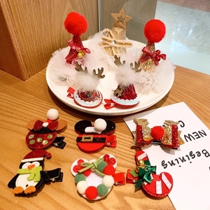 Christmas reindeer antler hair clip set with plush pompons and festive bow decorations