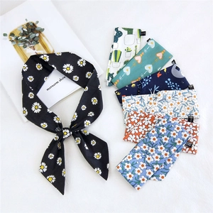 Fashionable cotton linen long neck scarf with black daisy floral pattern on magazine