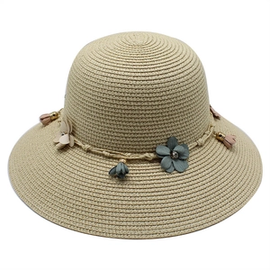 Women's foldable wide brim straw sun hat with decorative floral accents and rope band