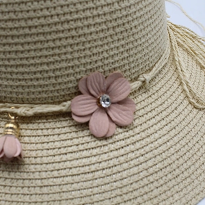 Straw sun hat with pink fabric flower, rhinestone accent and tassel for women