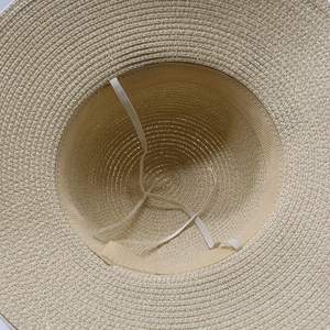 Detail of woven straw hat interior featuring sweatband and elastic windproof strap