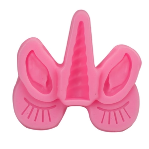 Pink silicone unicorn mold featuring spiral horn, ears and eyelashes for fondant cake decorating