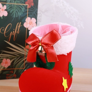 Red flocked Christmas boot candy bag with plush white trim, gold bell and green tree
