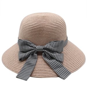 Summer straw sun hat for women with a black and white gingham bow decoration