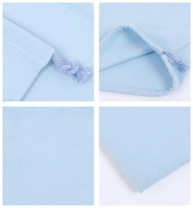 Macro details of blue cotton drawstring bag showing fabric texture and stitched knots
