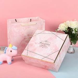 Close-up of pink marble texture gift box with Best Wishes text and gold line accents